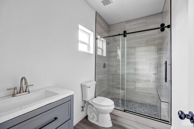 1627 Tejon St, Bakersfield, CA 93305 - bathroom with toilet, a shower stall, vanity, and wood finished floors