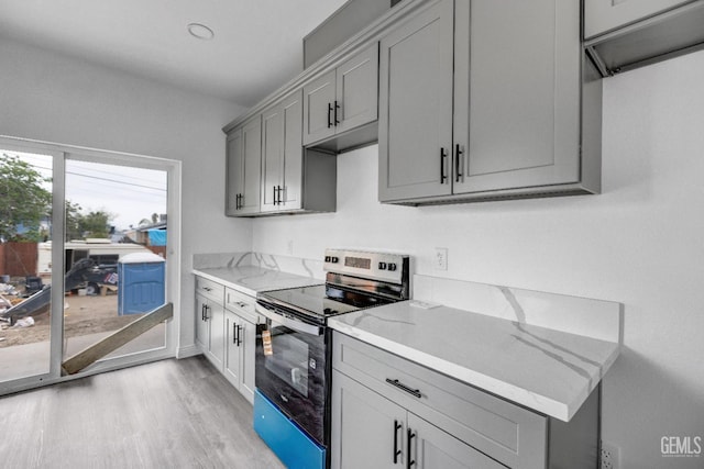 1627 Tejon St, Bakersfield, CA 93305 - kitchen featuring electric range, gray cabinets, light wood-style floors, and light stone countertops