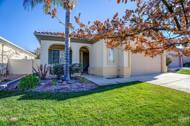 mediterranean / spanish house with a front lawn and a garage