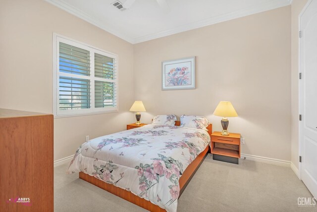 carpeted bedroom with ornamental molding and ceiling fan