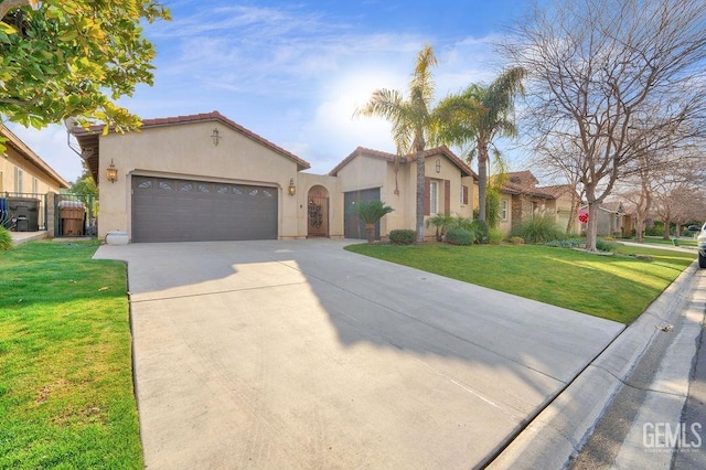 mediterranean / spanish house featuring a garage and a front yard