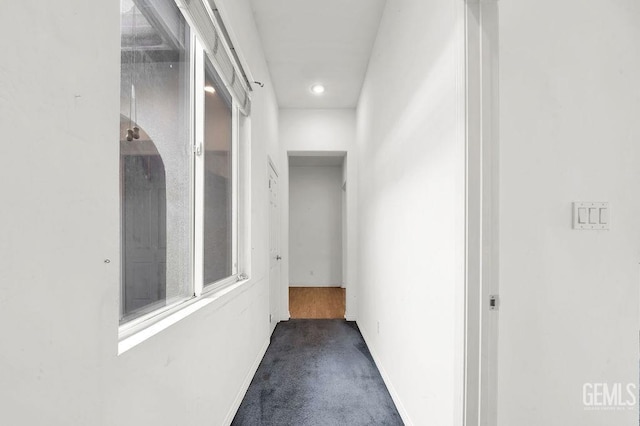 hall with carpet floors, recessed lighting, and baseboards