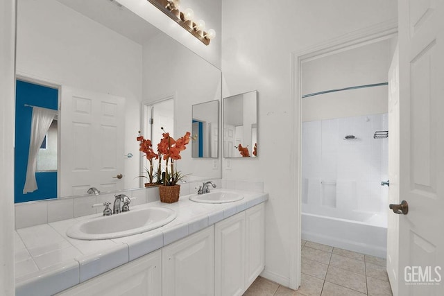 full bathroom with tile patterned flooring, a sink, shower / tub combination, and double vanity
