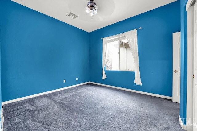 carpeted empty room with baseboards, ceiling fan, and visible vents