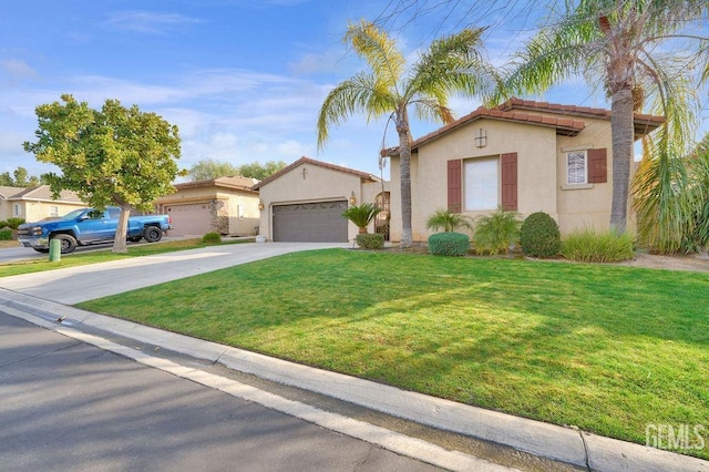 mediterranean / spanish house with a garage and a front yard