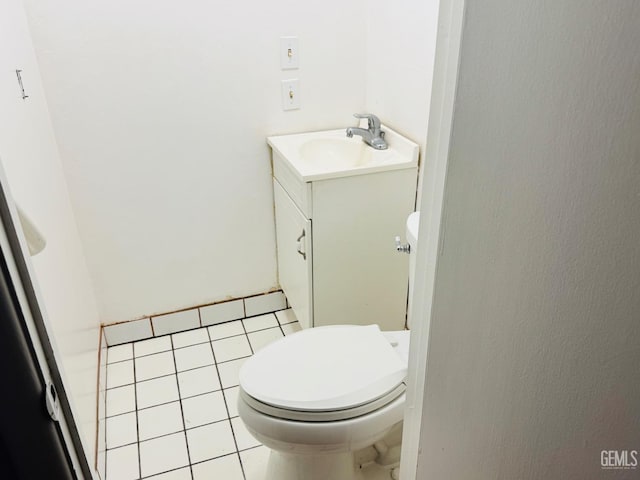 bathroom featuring toilet, vanity, and tile patterned floors