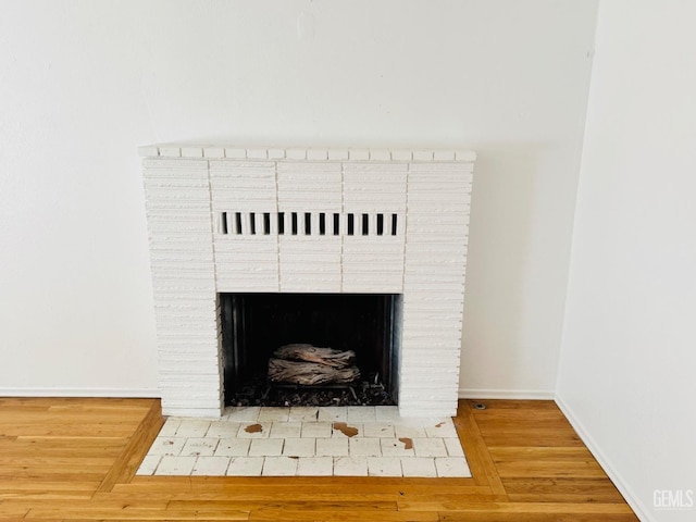 interior details featuring a brick fireplace