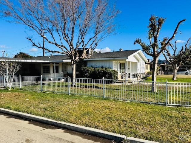 single story home with a front yard and a carport