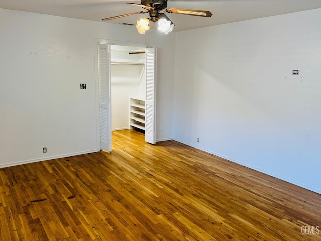 spare room with ceiling fan and wood-type flooring