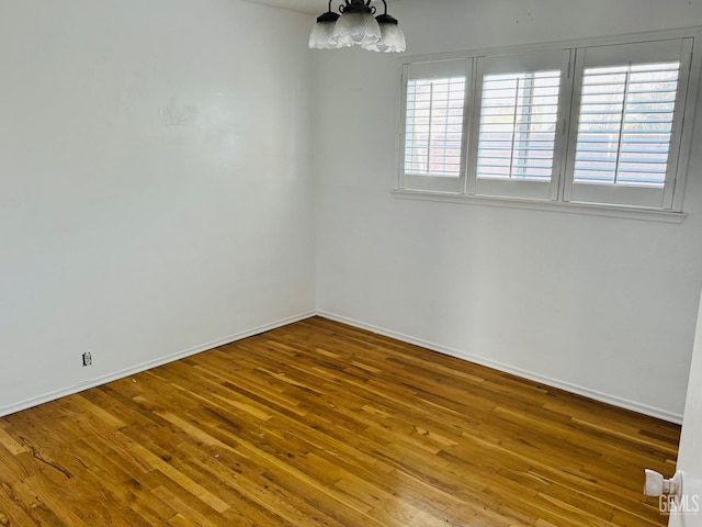 unfurnished room with hardwood / wood-style flooring