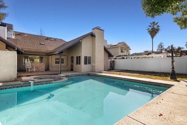 view of pool with a fenced in pool, an in ground hot tub, a patio, and fence