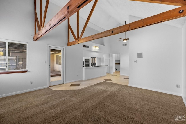 unfurnished living room with beamed ceiling, light carpet, visible vents, and a ceiling fan