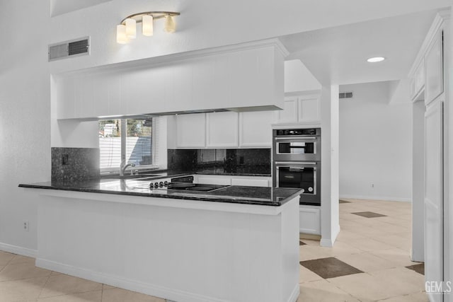 kitchen featuring visible vents, a sink, tasteful backsplash, stainless steel double oven, and black electric cooktop