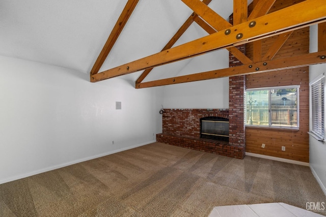 unfurnished living room featuring carpet flooring, a fireplace, vaulted ceiling with beams, and baseboards