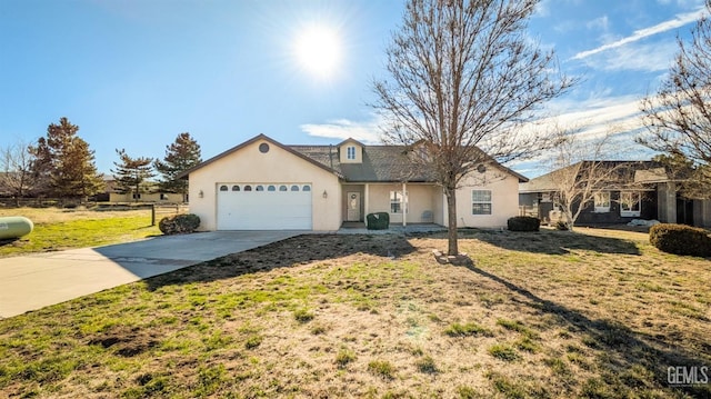 view of front of house featuring a garage, fence, driveway, stucco siding, and a front lawn