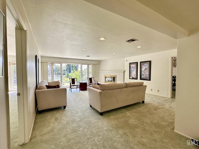 carpeted living room with a brick fireplace