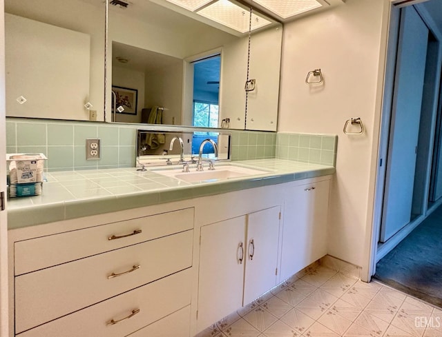 bathroom with vanity and backsplash