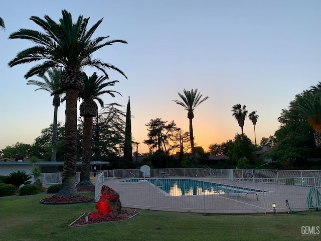 pool at dusk with a yard