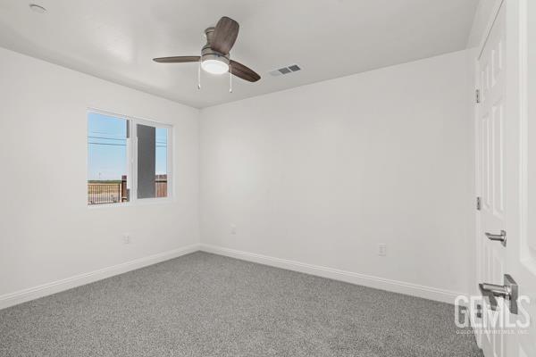 664 Fresno Ave, Shafter, CA 93263 - empty room featuring ceiling fan and carpet flooring