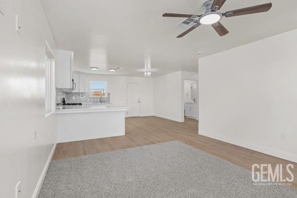 664 Fresno Ave, Shafter, CA 93263 - unfurnished living room featuring a ceiling fan and light wood finished floors