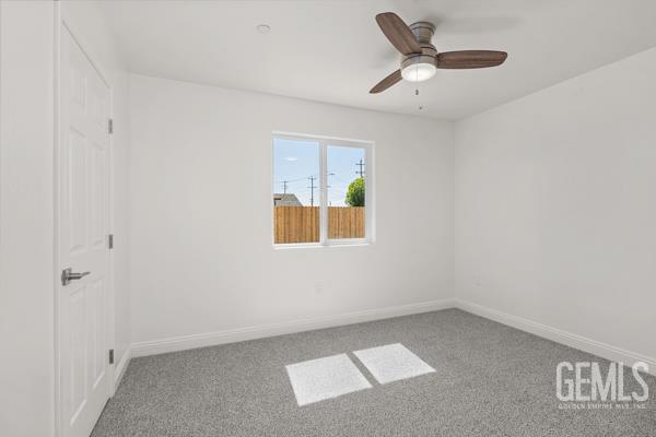 664 Fresno Ave, Shafter, CA 93263 - carpeted empty room featuring baseboards and a ceiling fan