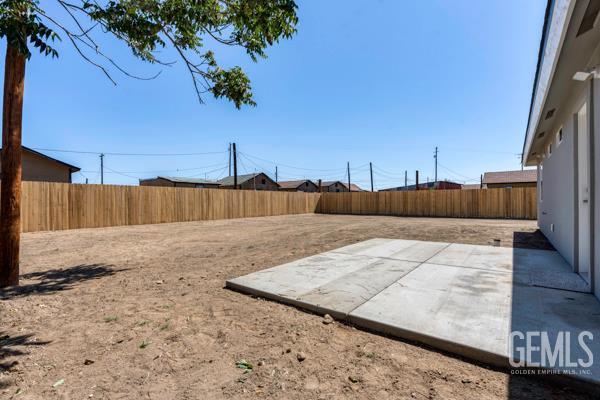 664 Fresno Ave, Shafter, CA 93263 - fenced backyard with a patio