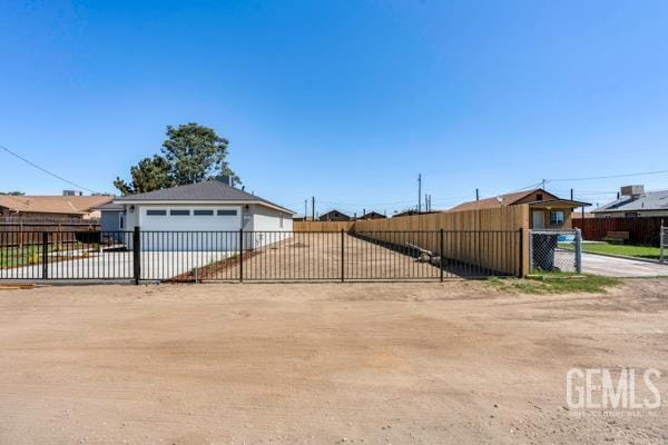 664 Fresno Ave, Shafter, CA 93263 - view of yard with a garage and dirt driveway