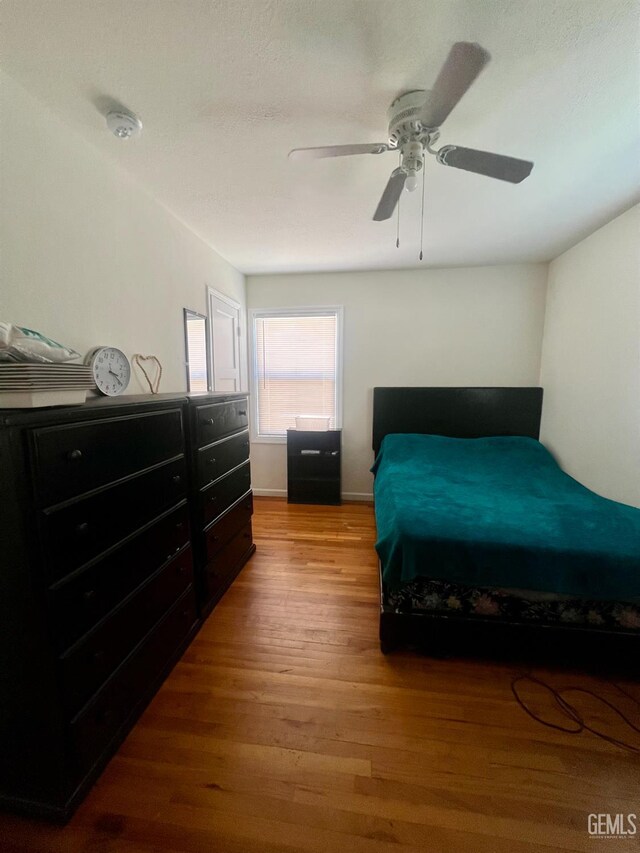 1405 Chester Ave, Bakersfield, CA 93301 - bedroom with wood finished floors and ceiling fan