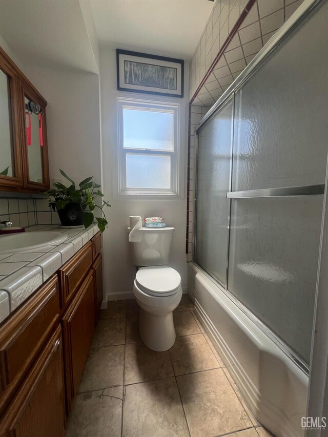 1405 Chester Ave, Bakersfield, CA 93301 - full bathroom featuring vanity, shower / bath combination with glass door, and tile patterned flooring
