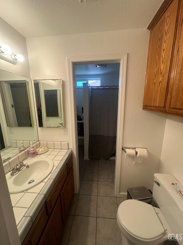 1405 Chester Ave, Bakersfield, CA 93301 - bathroom with vanity, tile patterned flooring, a shower with curtain, and a textured ceiling