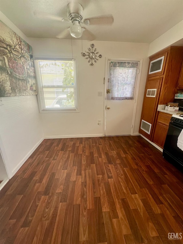 1405 Chester Ave, Bakersfield, CA 93301 - unfurnished dining area with dark wood-type flooring and ceiling fan