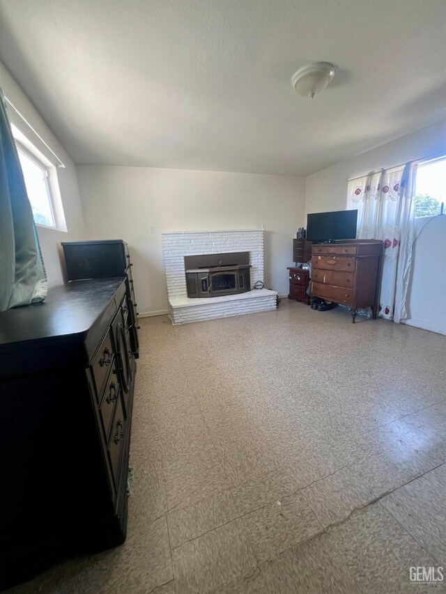 1405 Chester Ave, Bakersfield, CA 93301 - living room featuring plenty of natural light and a brick fireplace