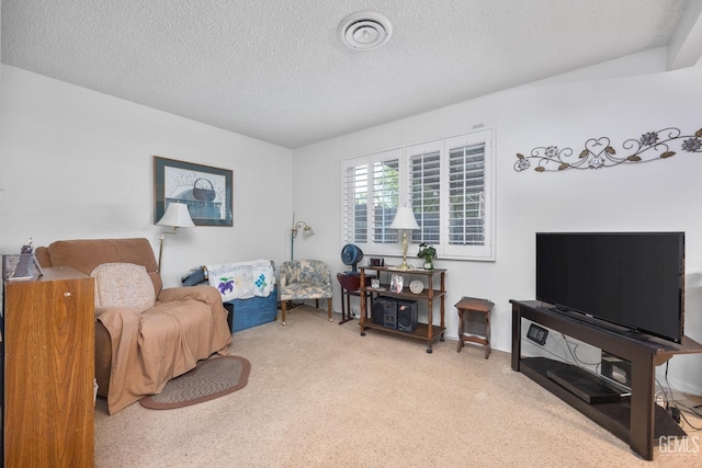 living area featuring carpet floors and a textured ceiling