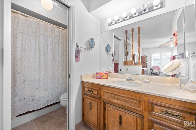 bathroom with ceiling fan, tile patterned floors, toilet, vanity, and a shower with shower curtain