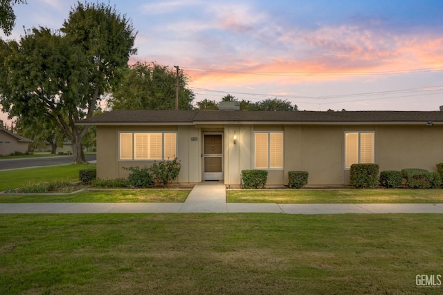 ranch-style house with a yard