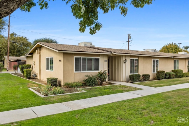 ranch-style home with a front lawn