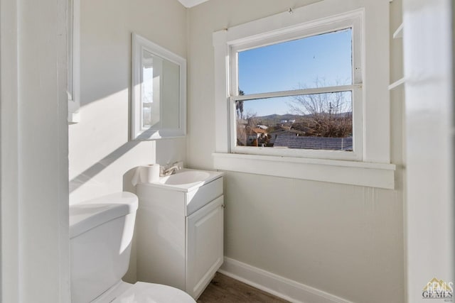 210 B B, Taft, CA 93268 - half bath featuring toilet, vanity, baseboards, and wood finished floors