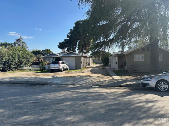 view of front facade with a garage and fence