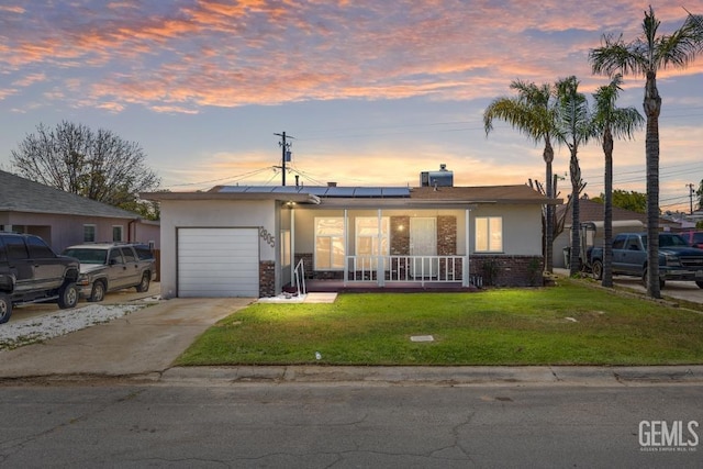 2805 Charleston Dr, Bakersfield, CA 93308 - view of front of house featuring solar panels, a porch, a garage, a front lawn, and driveway