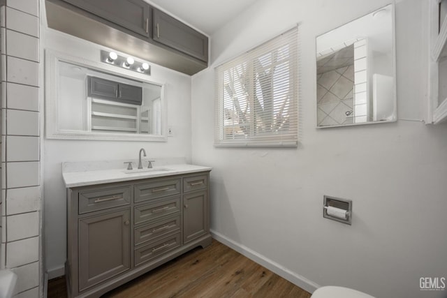 2805 Charleston Dr, Bakersfield, CA 93308 - bathroom with toilet, wood finished floors, vanity, and baseboards