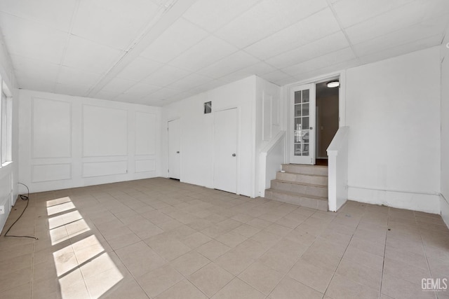 2805 Charleston Dr, Bakersfield, CA 93308 - spare room with a decorative wall, light tile patterned floors, and a drop ceiling
