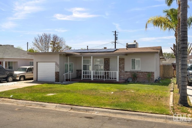 2805 Charleston Dr, Bakersfield, CA 93308 - ranch-style house featuring driveway, a front lawn, solar panels, a garage, and covered porch