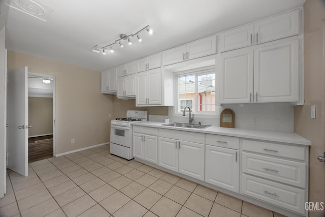 2805 Charleston Dr, Bakersfield, CA 93308 - kitchen featuring light countertops, a sink, white range with gas stovetop, and white cabinets