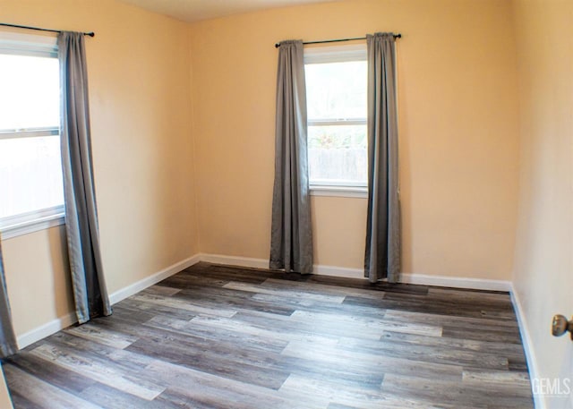 unfurnished room with wood-type flooring