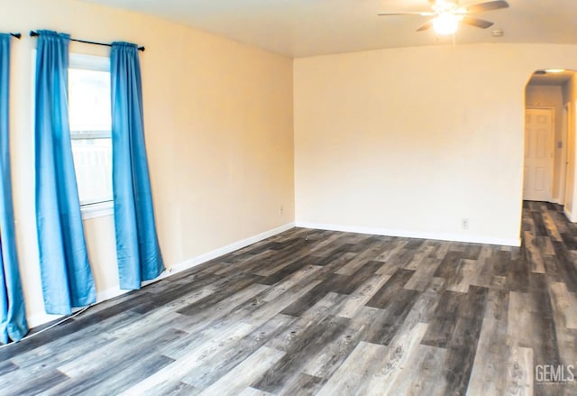 unfurnished room with ceiling fan and dark wood-type flooring