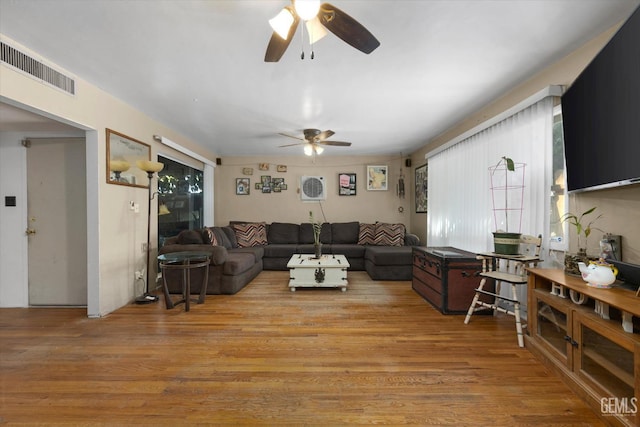 living room featuring light hardwood / wood-style flooring and ceiling fan