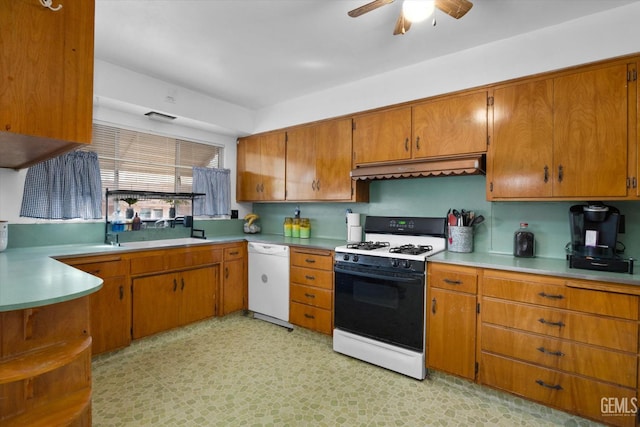 kitchen with white appliances, ceiling fan, and sink