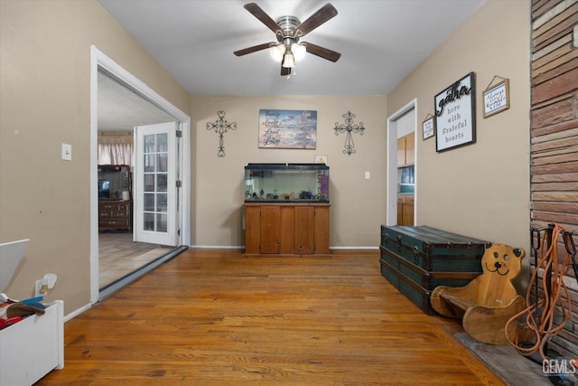 living area featuring ceiling fan and light hardwood / wood-style floors