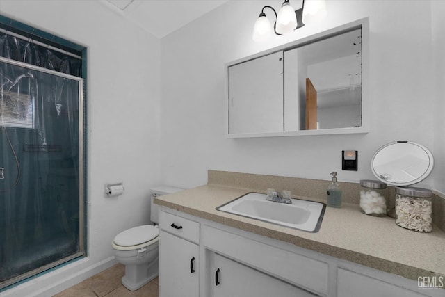 bathroom featuring tile patterned floors, a shower, vanity, and toilet