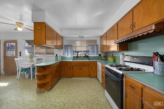 kitchen featuring ceiling fan, sink, white appliances, and kitchen peninsula